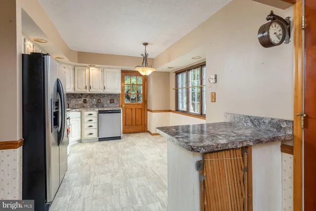 a kitchen with a refrigerator sink and microwave