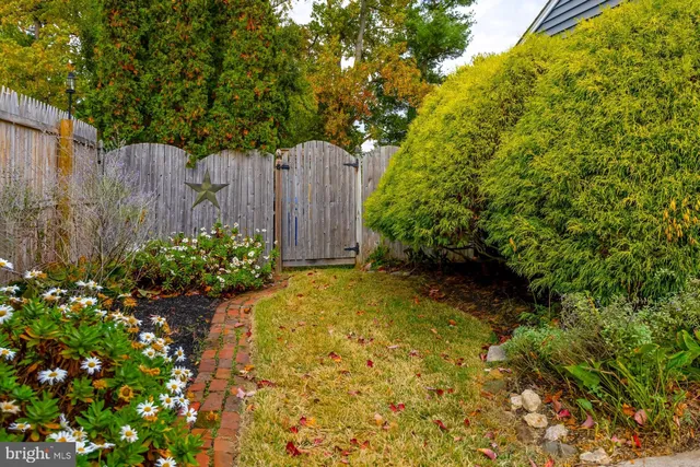 a view of a garden with wooden fence