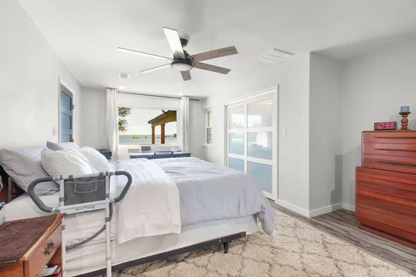 a bedroom with a bed and a mirror