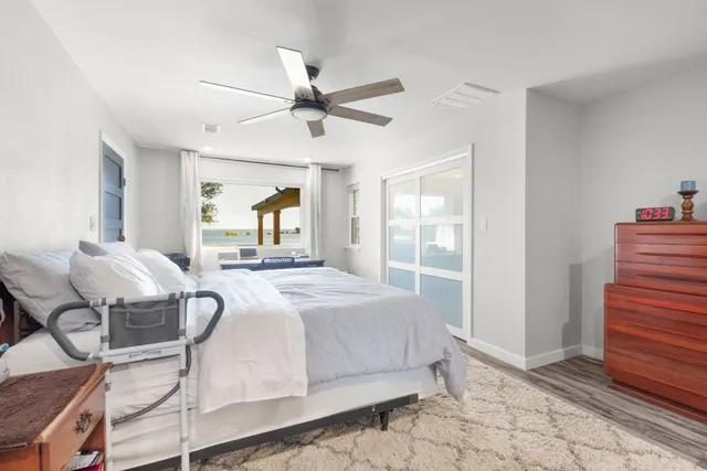 a bedroom with a bed and a mirror