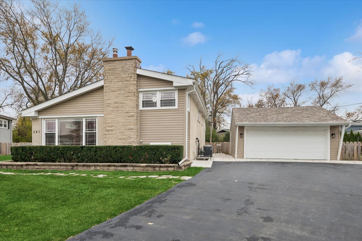 241 Glendale Road Glenview, IL 60025 - Photo 23 of 29 a front view of a house with a garden and yard