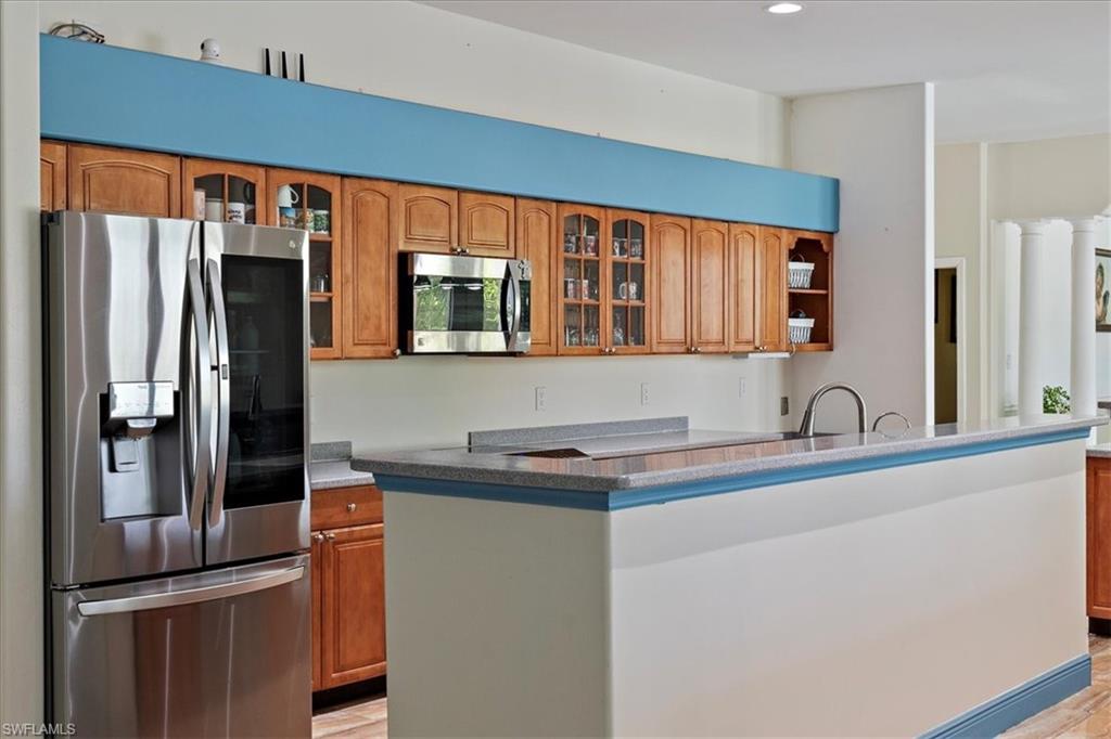 4281 68th Avenue Northeast Naples, FL 34120 - Photo 13 of 41 a kitchen with stainless steel appliances granite countertop a refrigerator and a sink