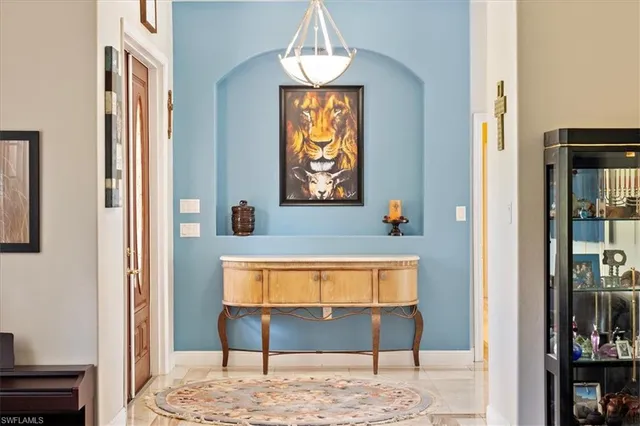 a view of hallway with window and wooden floor