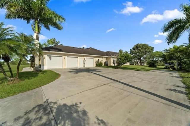 a front view of a house with a yard and a garage