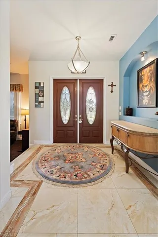 a living room with chair and a clock