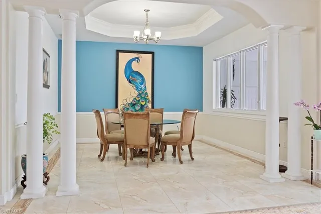 a view of a dining room with furniture and chandelier