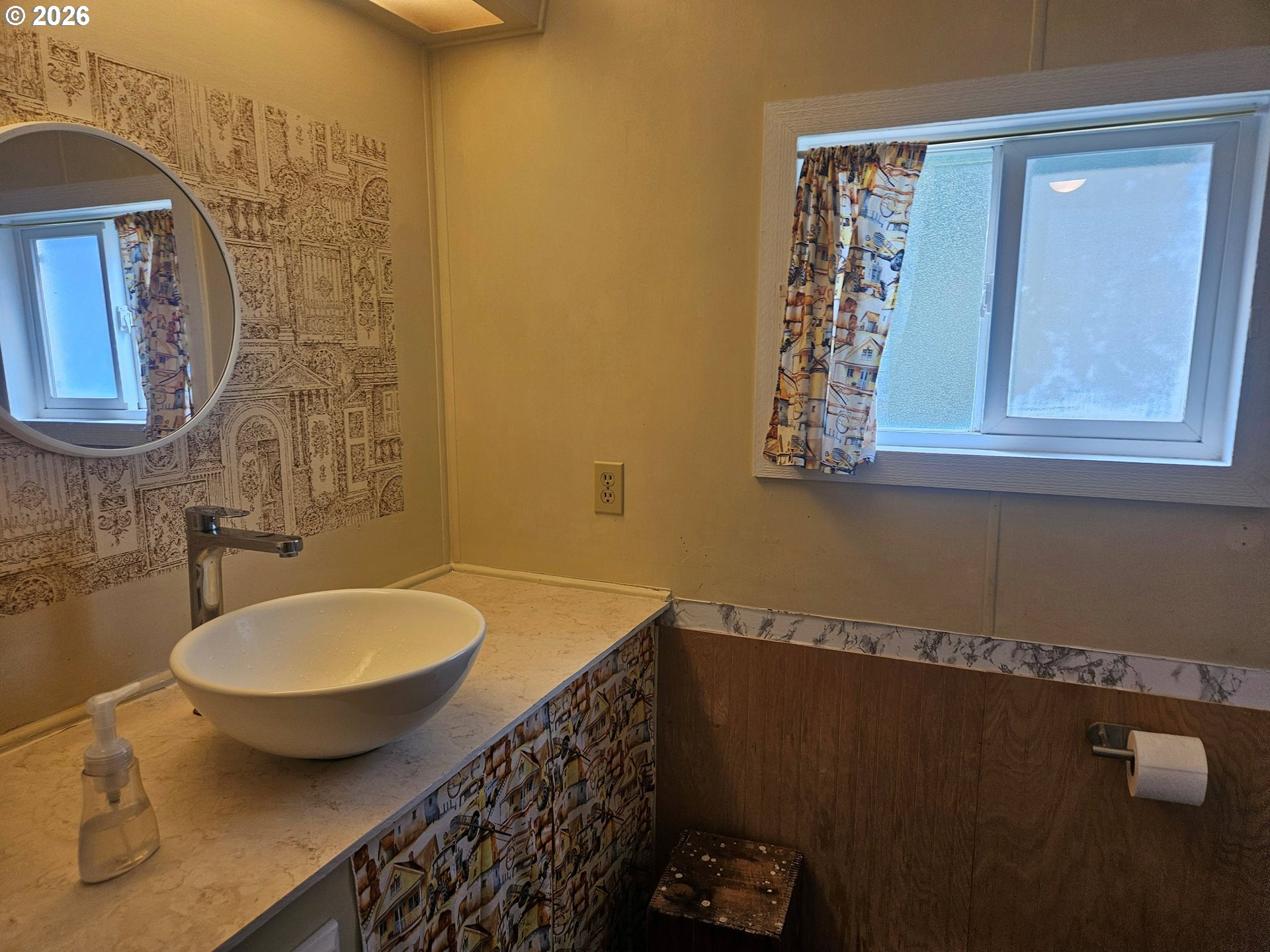 1600 Rhododendron Drive, Unit 214 Florence, OR 97439 - Photo 13 of 38 a bathroom with a toilet a sink and mirror