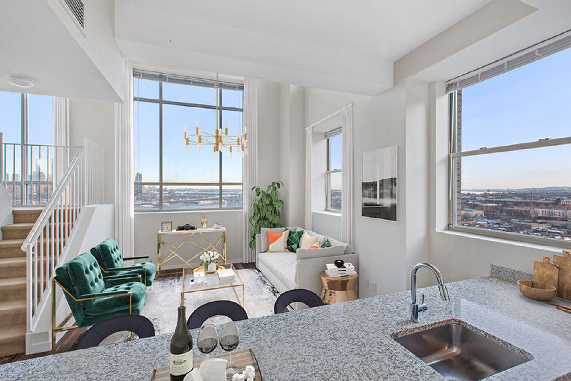 20 Beacon Way, Unit TB04 Jersey City, NJ 07304 - Photo 3 of 21 a living room with furniture and a potted plant