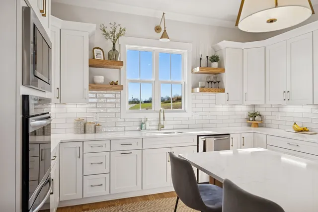 a kitchen with a table chairs refrigerator and cabinets