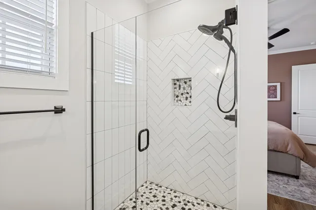 a bathroom with a granite countertop sink a toilet and shower