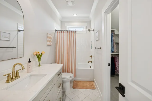 a spacious bedroom with a bed and a chandelier
