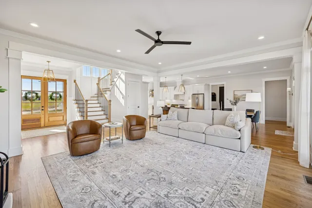 a living room with furniture a fireplace and kitchen view