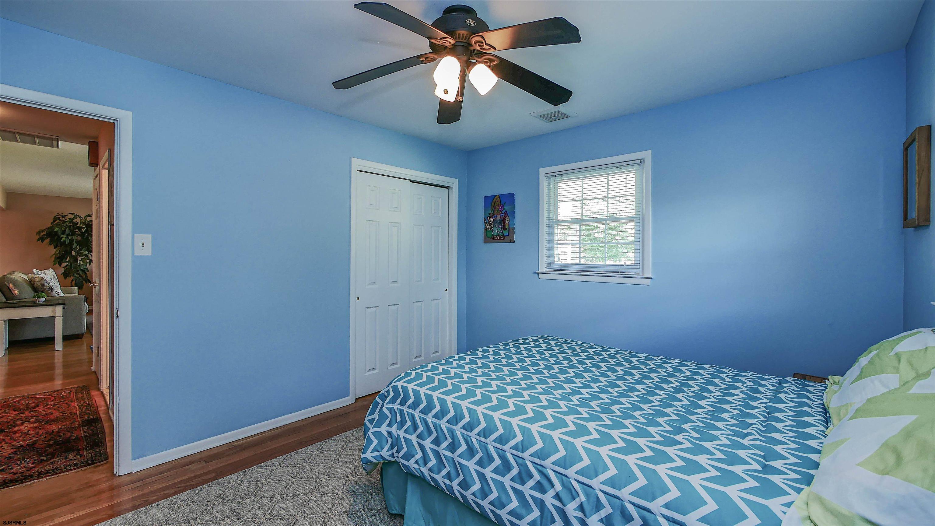 8 Malvern Road Somers Point, NJ 08244 - Photo 17 of 31 a bedroom with a bed and a chandelier