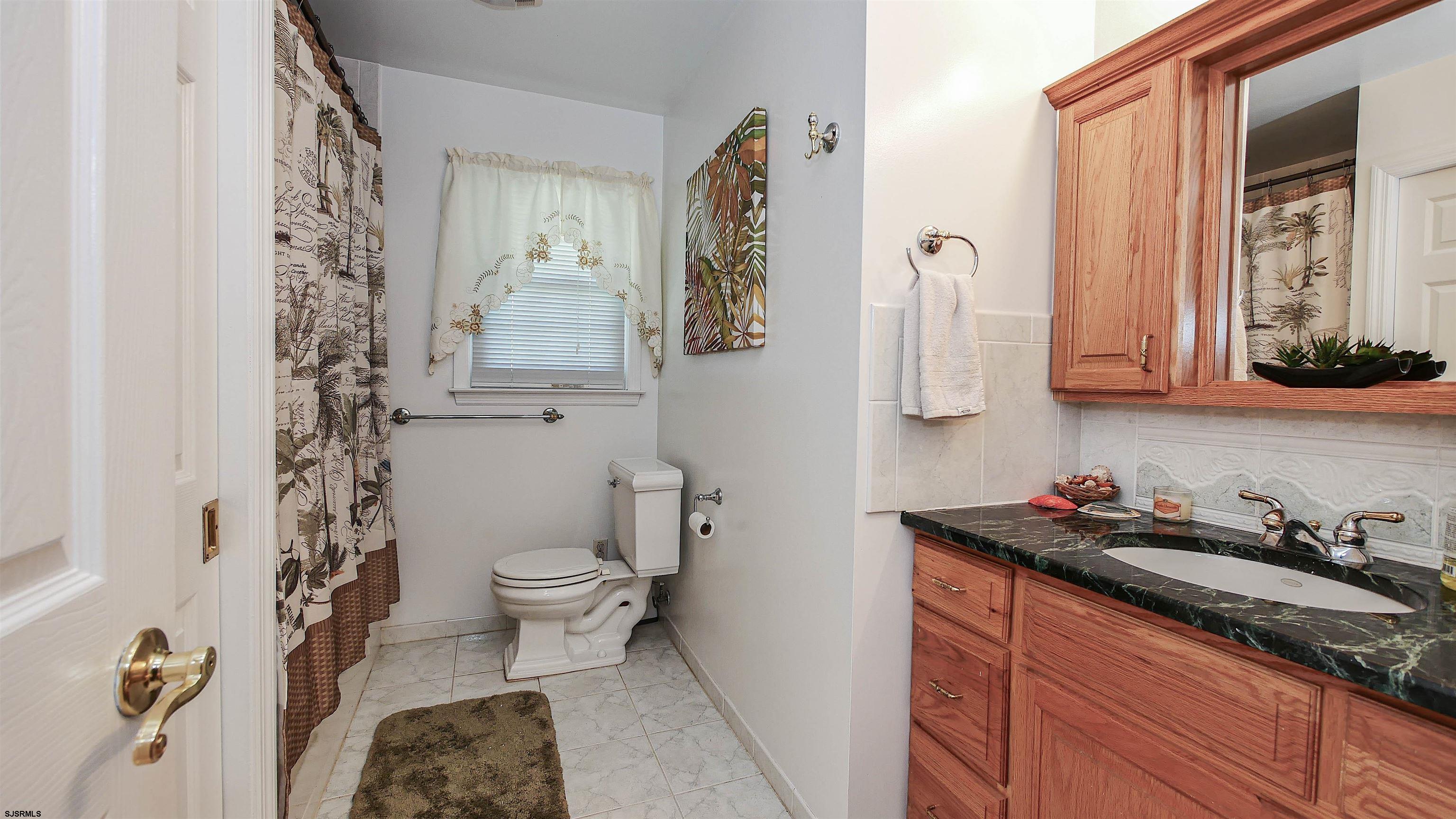 8 Malvern Road Somers Point, NJ 08244 - Photo 18 of 31 a bathroom with a granite countertop sink toilet and mirror