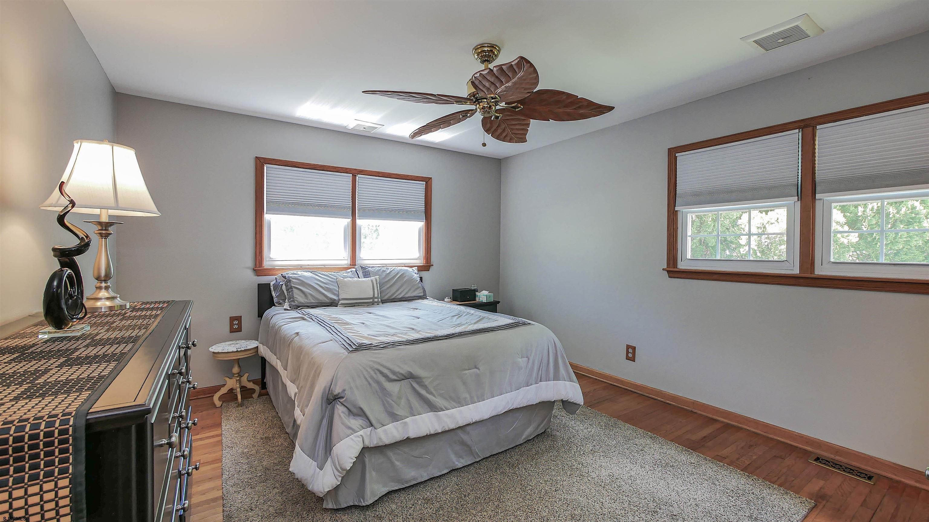 8 Malvern Road Somers Point, NJ 08244 - Photo 19 of 31 a bedroom with a bed and a chandelier