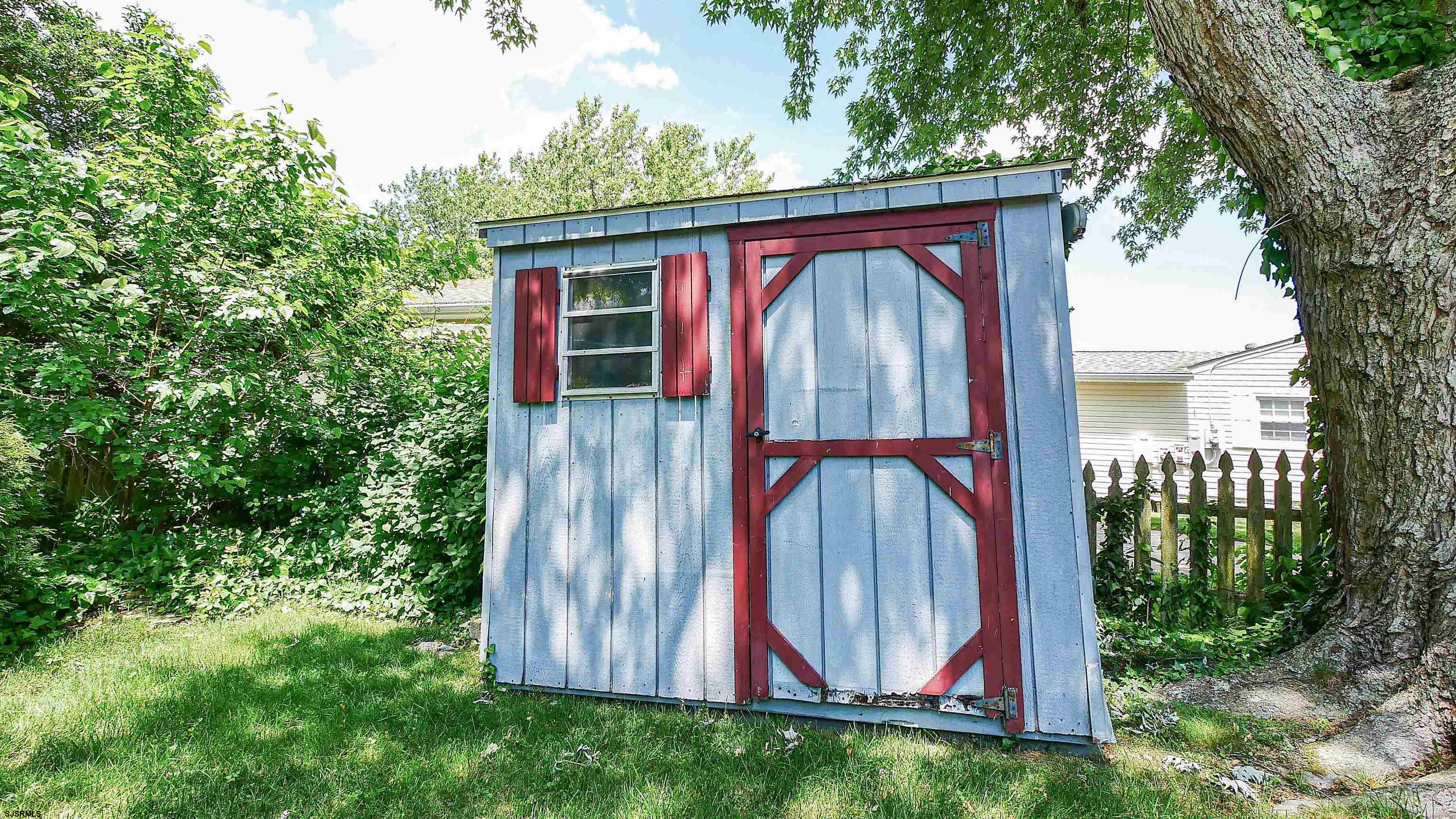 8 Malvern Road Somers Point, NJ 08244 - Photo 29 of 31 a view of a house with a small yard and a large tree
