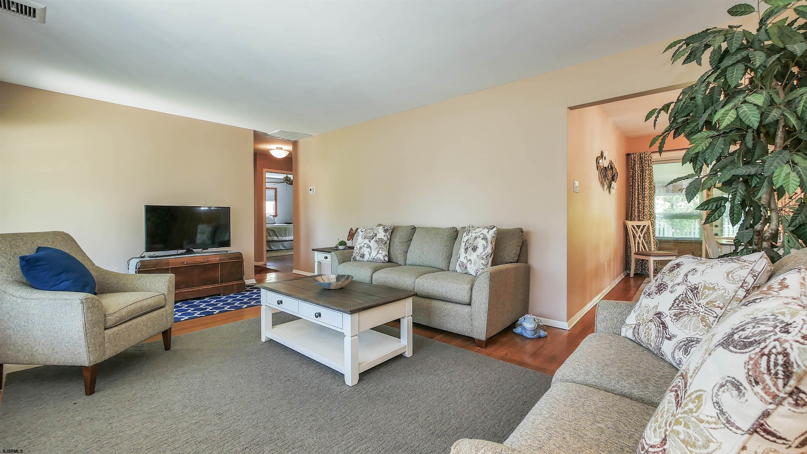 8 Malvern Road Somers Point, NJ 08244 - Photo 4 of 31 a living room with furniture and a flat screen tv