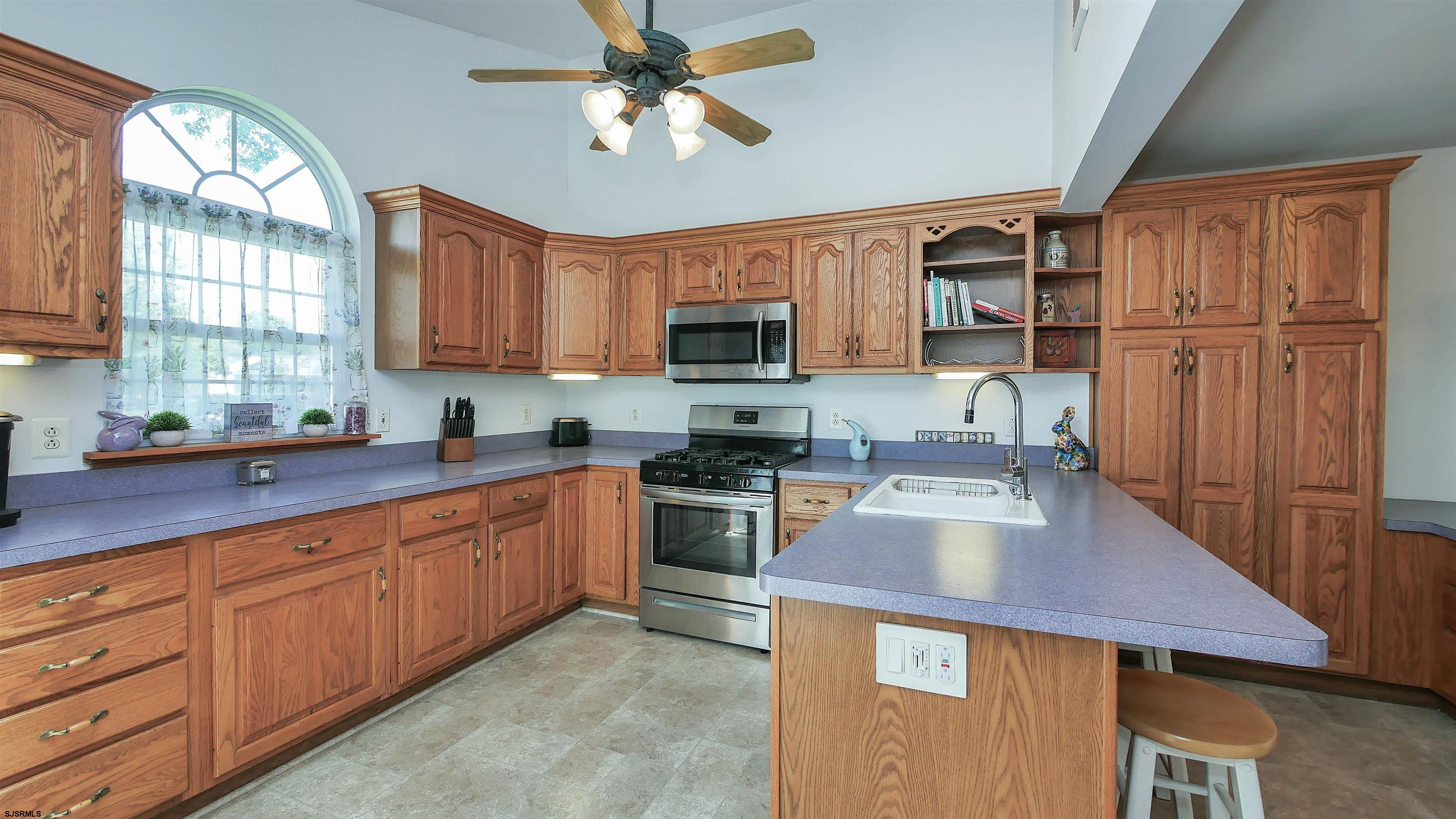 8 Malvern Road Somers Point, NJ 08244 - Photo 10 of 31 a kitchen with stainless steel appliances granite countertop a stove refrigerator sink and microwave