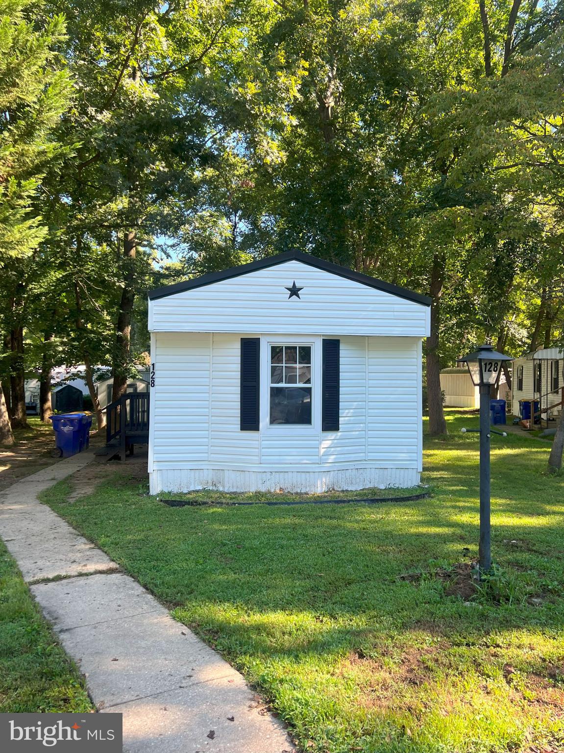 128 Ivy Ridge Court, Unit 128 Smyrna, DE 19977 - Photo 2 of 12 a front view of a house with garden