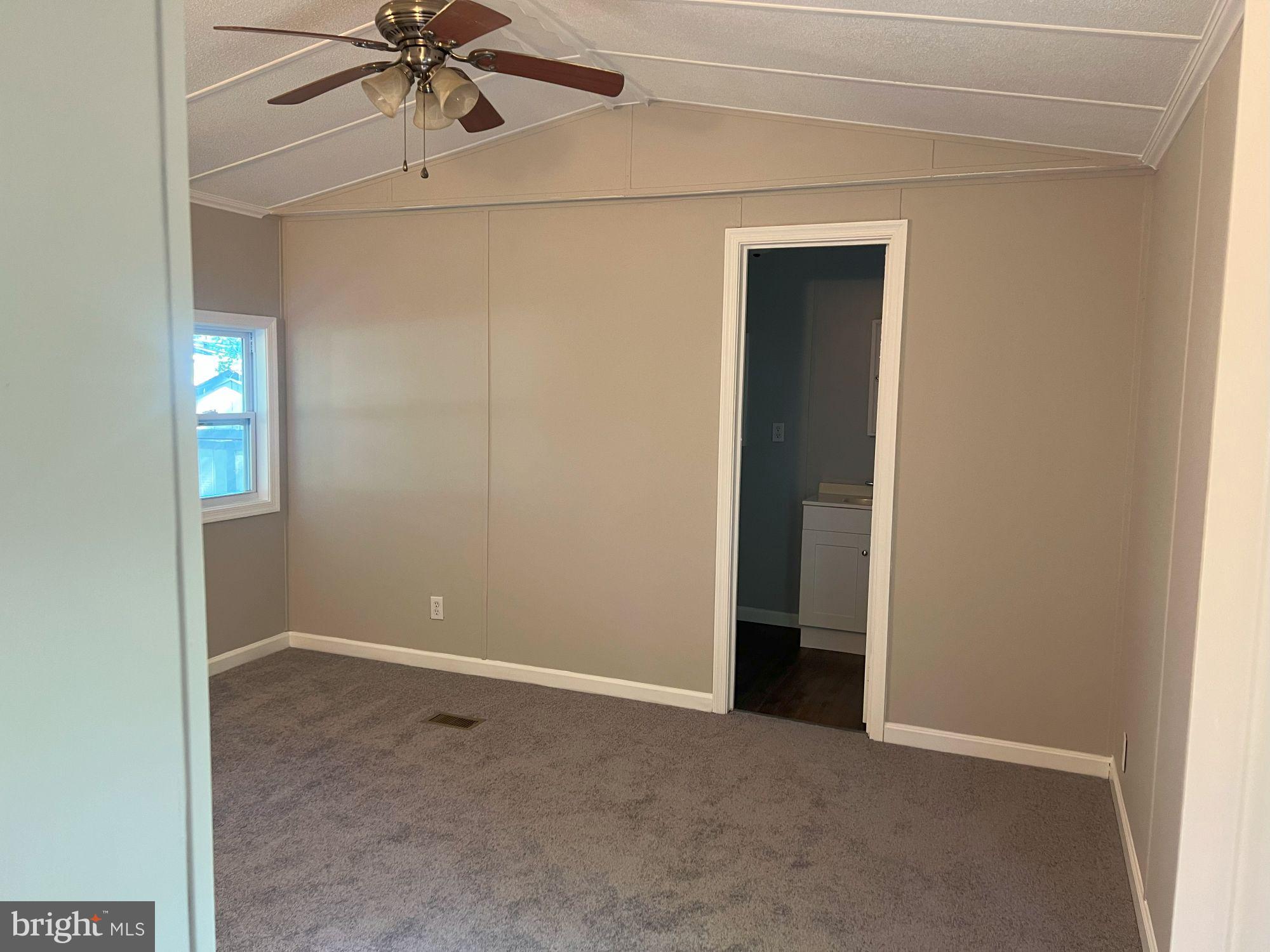 128 Ivy Ridge Court, Unit 128 Smyrna, DE 19977 - Photo 9 of 12 an empty room with fan