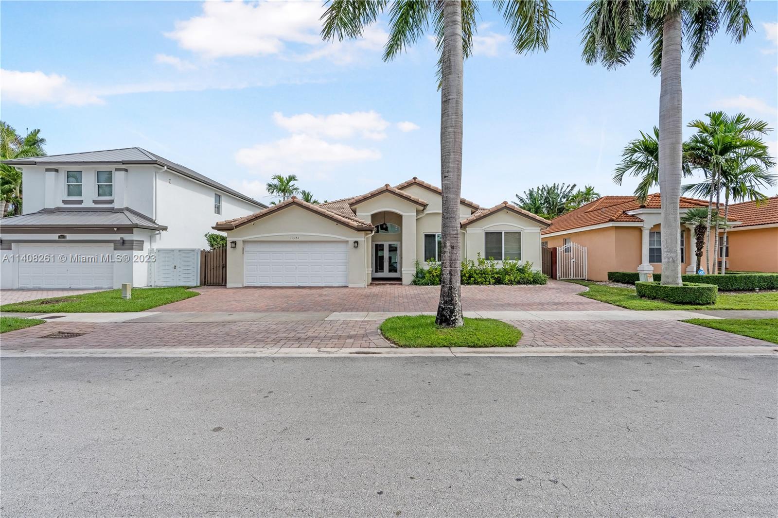 13151 Northwest 7th Street Miami, FL 33172 - Photo 2 of 48 a front view of a house with a garden and yard