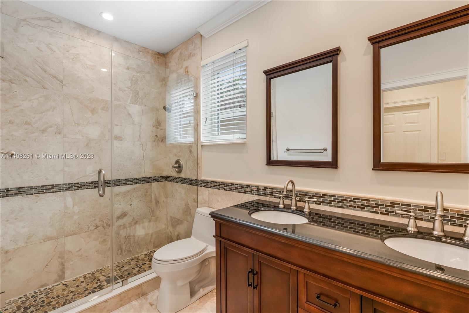 13151 Northwest 7th Street Miami, FL 33172 - Photo 32 of 48 a bathroom with a granite countertop sink toilet and a mirror