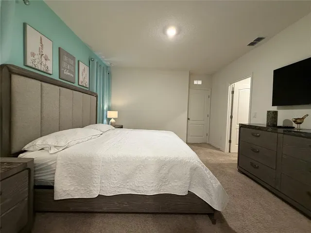 a bathroom with a granite countertop sink a toilet and a mirror