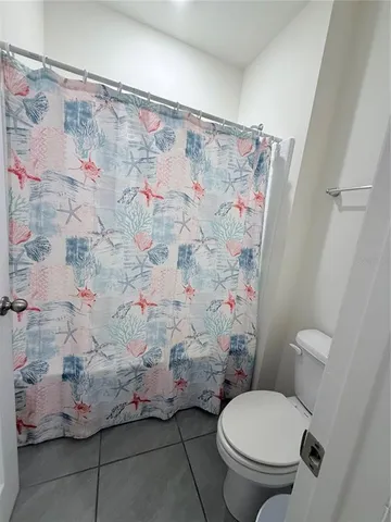 a living room with glass door and furniture