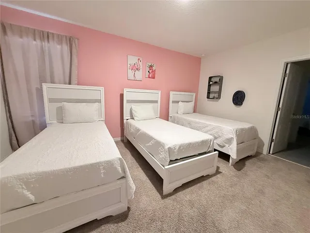 a view of a dry yard with wooden fence