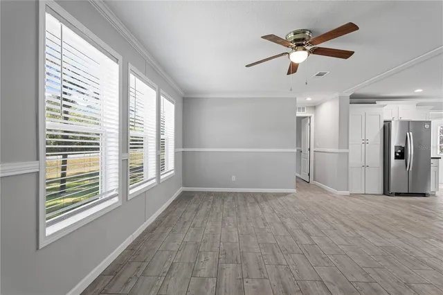 a living room with furniture a flat screen tv and a large window