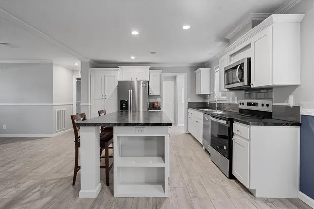 a metallic refrigerator freezer sitting in a kitchen