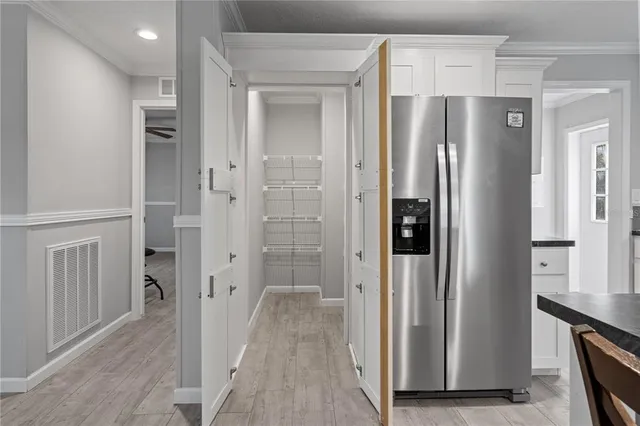 a kitchen with granite countertop white cabinets stainless steel appliances and a sink