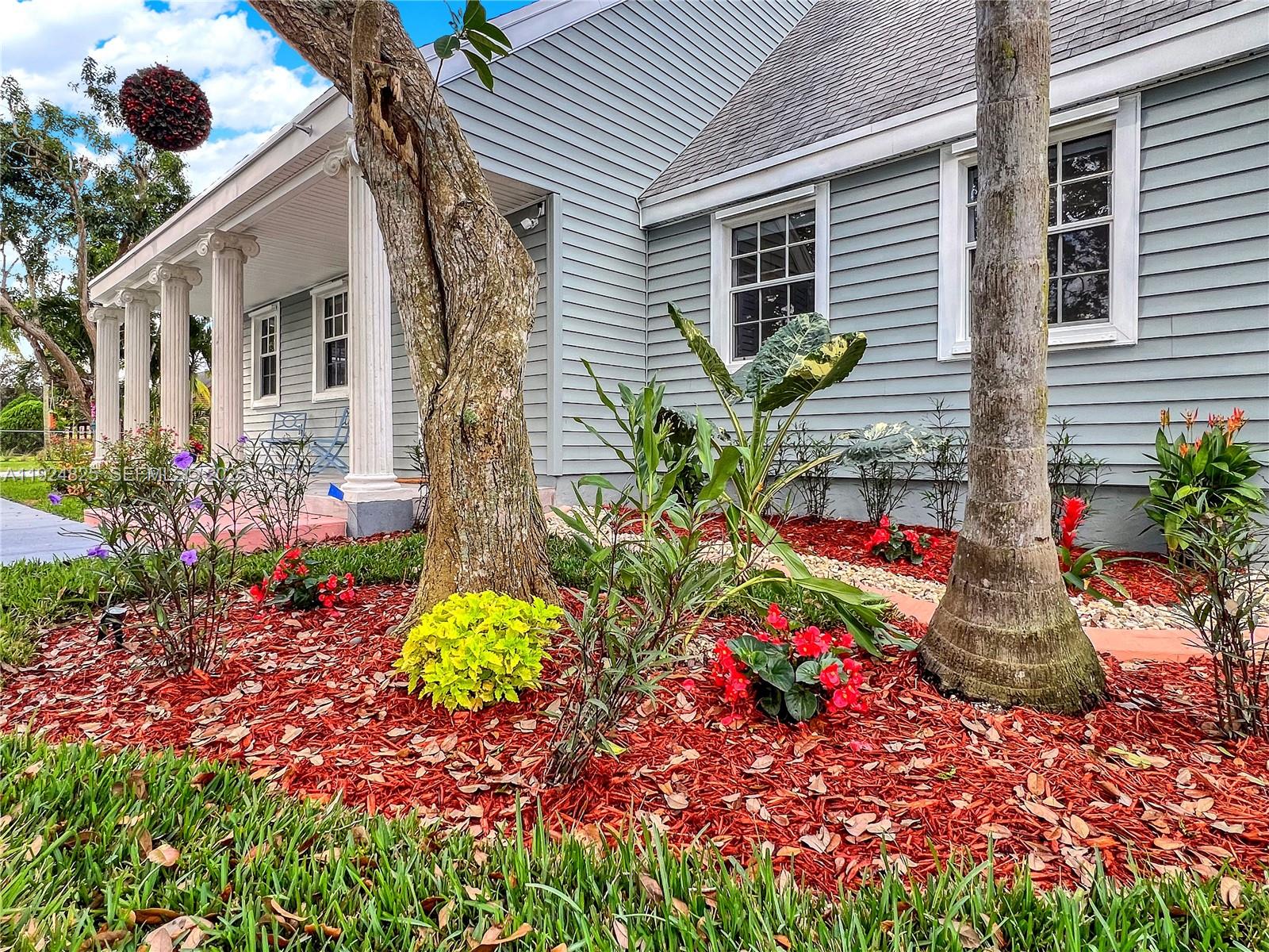 22820 Southwest 179th Place Miami, FL 33170 - Photo 14 of 56 a front view of a house with a yard and garden