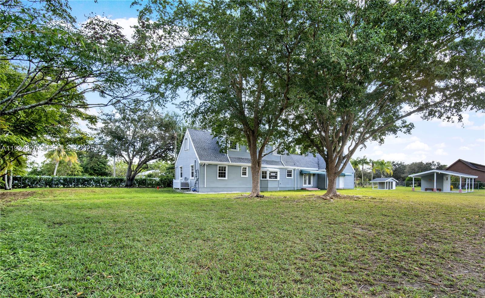 22820 Southwest 179th Place Miami, FL 33170 - Photo 18 of 56 a house view with swimming pool in front of it