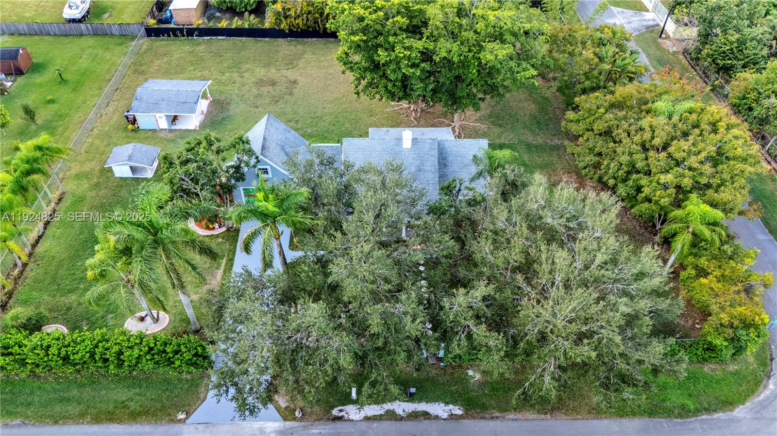 22820 Southwest 179th Place Miami, FL 33170 - Photo 20 of 56 an aerial view of a house with a yard and lake view