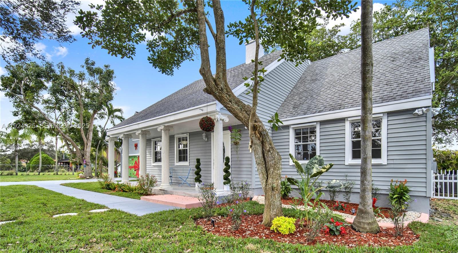 22820 Southwest 179th Place Miami, FL 33170 - Photo 2 of 56 a front view of a house with garden