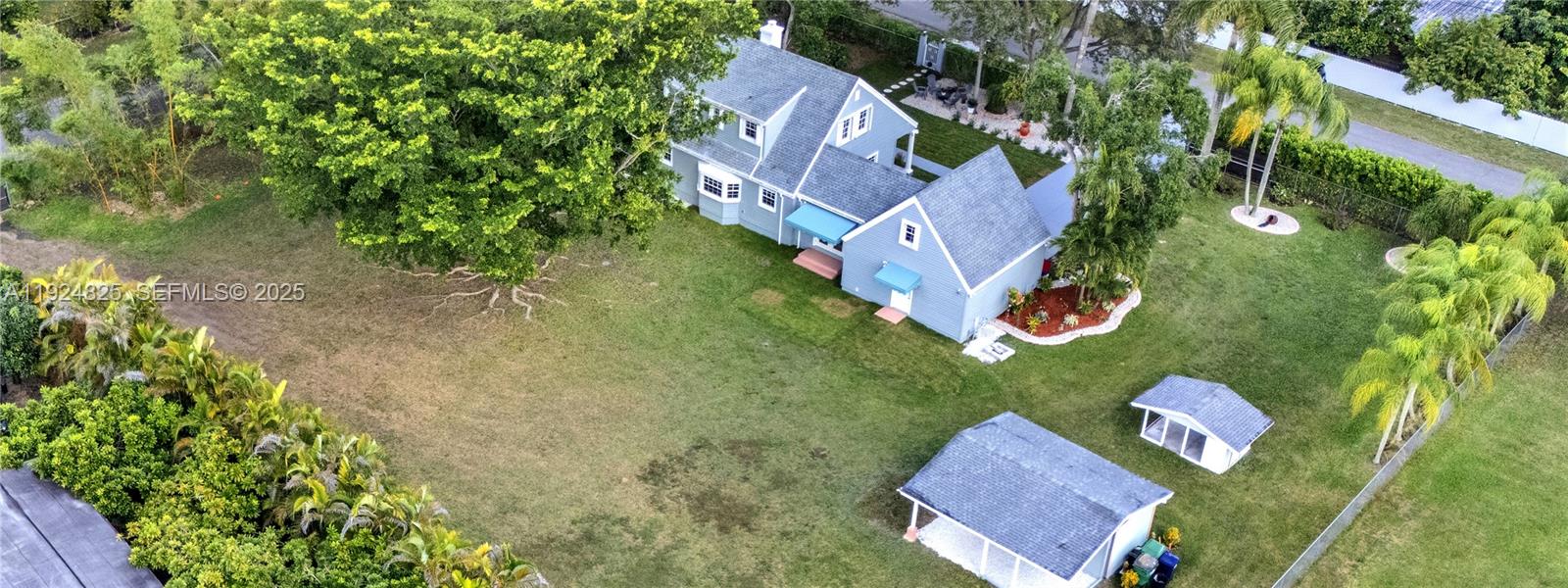 22820 Southwest 179th Place Miami, FL 33170 - Photo 21 of 56 an aerial view of a house with garden space and street view