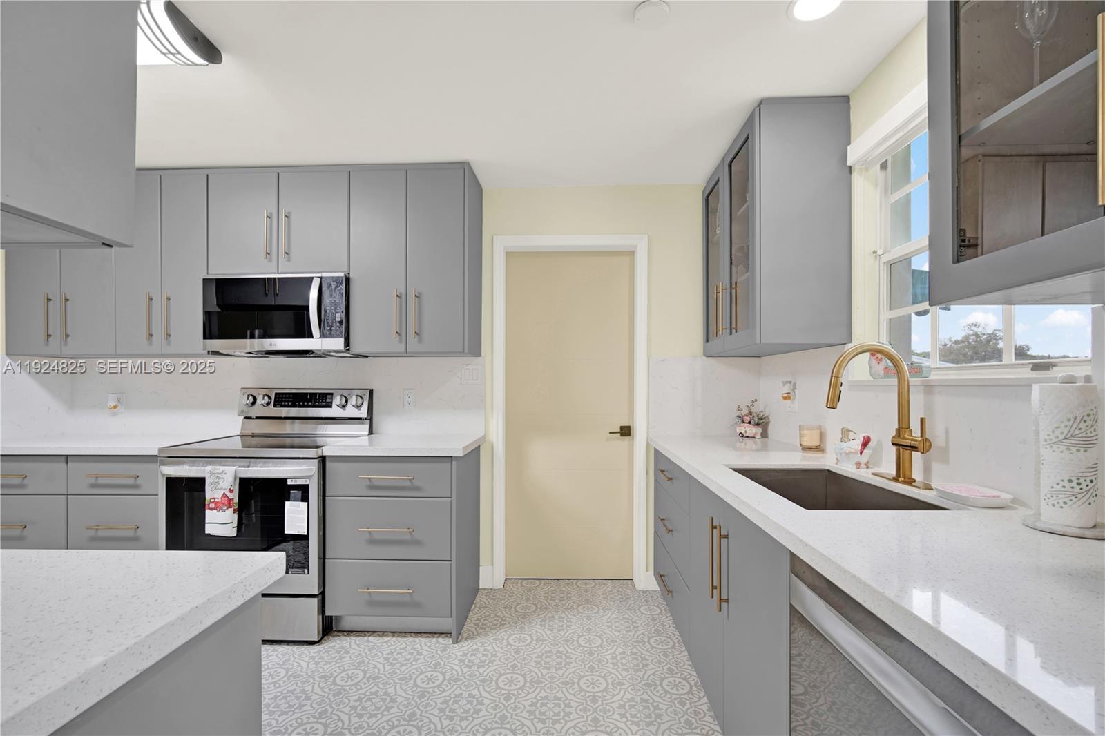 22820 Southwest 179th Place Miami, FL 33170 - Photo 31 of 56 a kitchen with a sink stove top oven and cabinets