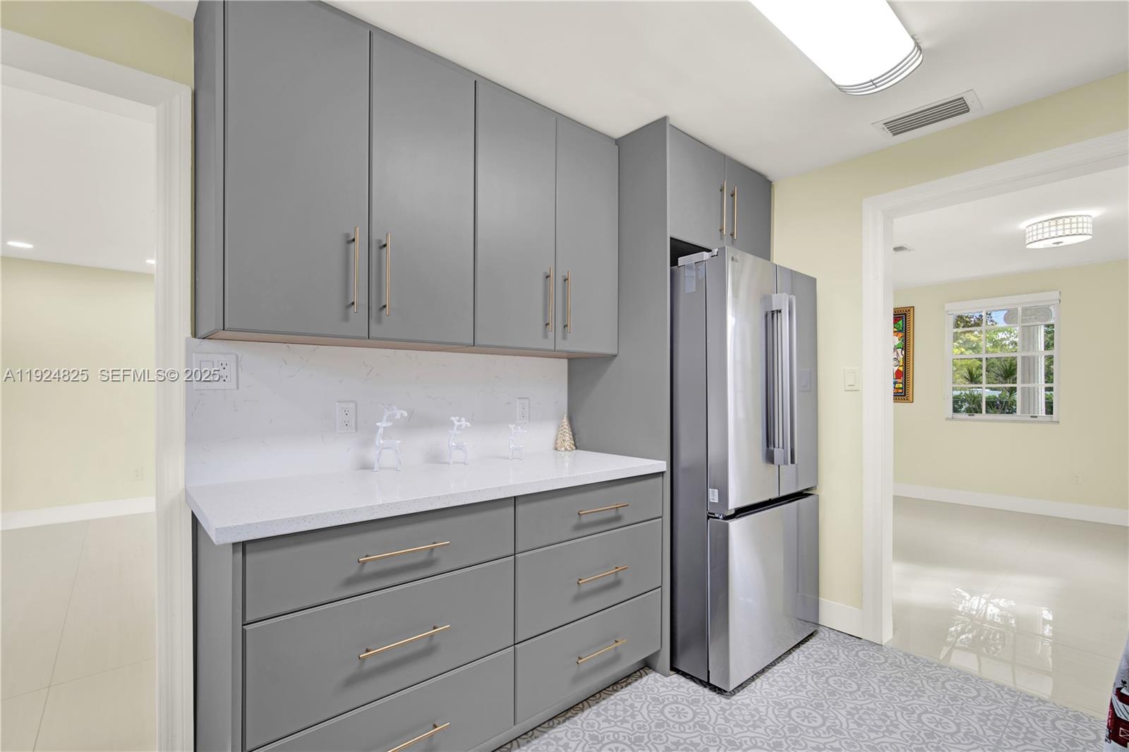22820 Southwest 179th Place Miami, FL 33170 - Photo 32 of 56 a kitchen with a refrigerator and cabinets