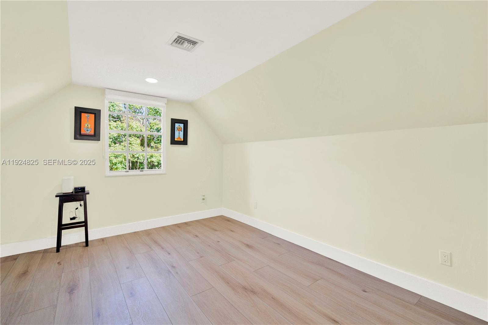22820 Southwest 179th Place Miami, FL 33170 - Photo 51 of 56 a view of an empty room with wooden floor and a window