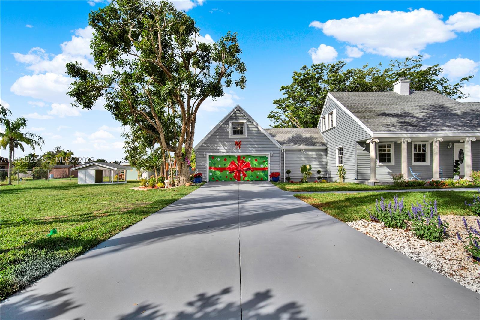 22820 Southwest 179th Place Miami, FL 33170 - Photo 8 of 56 a house view with garden space and trees