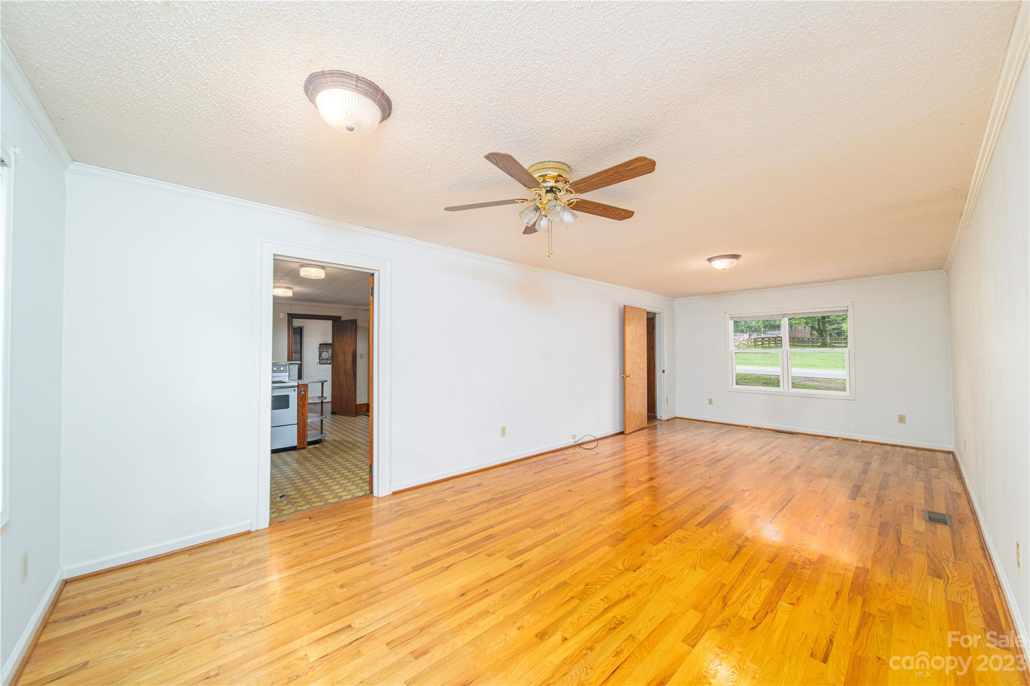 3980 Woodleaf Road Salisbury, NC 28147 - Photo 15 of 34 a view of a big room with wooden floor and a ceiling fan