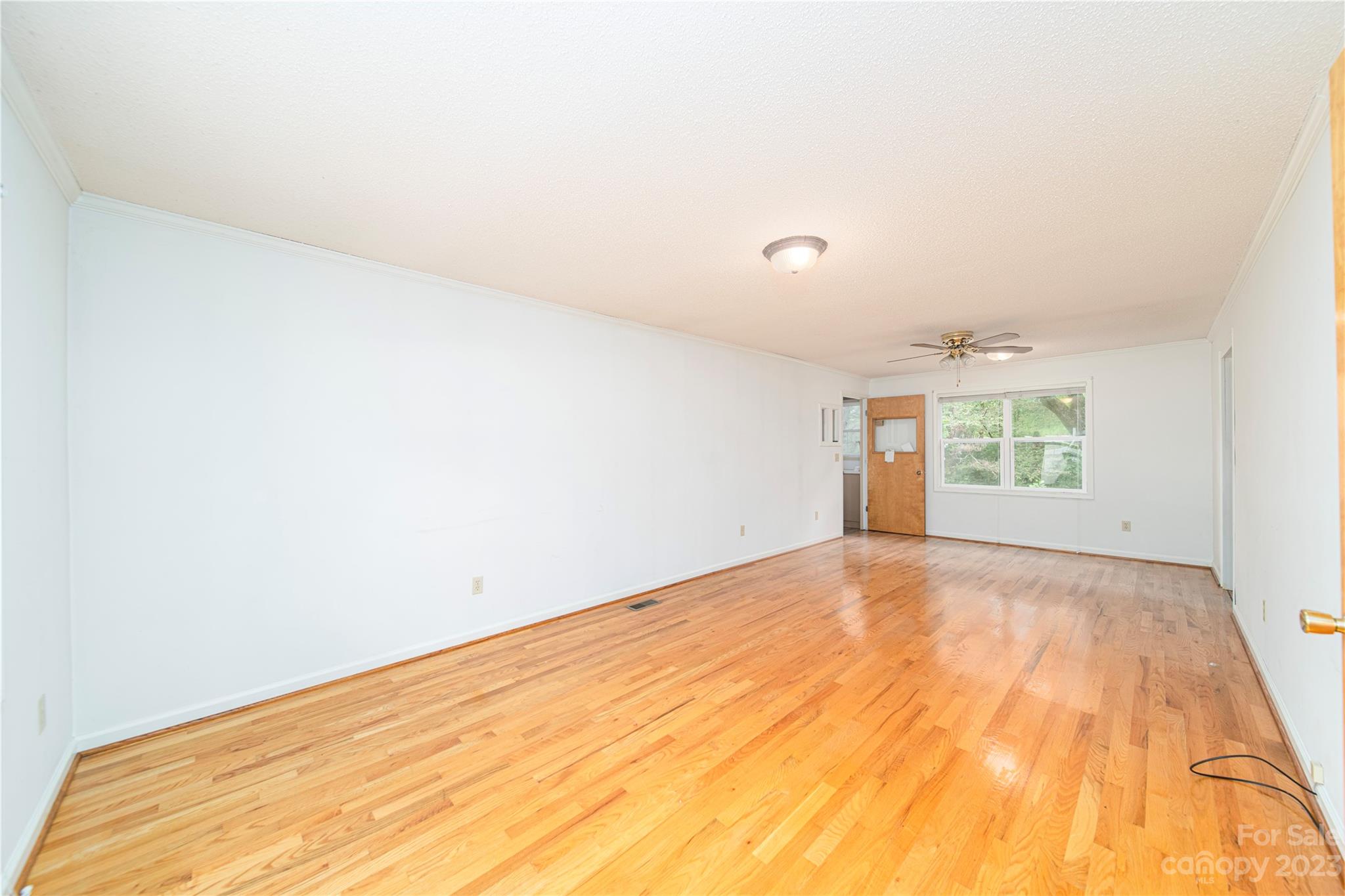 3980 Woodleaf Road Salisbury, NC 28147 - Photo 16 of 34 a view of an empty room with wooden floor and a window