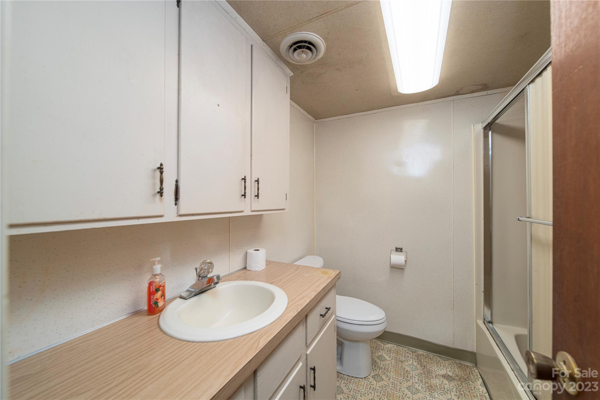 3980 Woodleaf Road Salisbury, NC 28147 - Photo 24 of 34 a bathroom with a sink vanity mirror and toilet