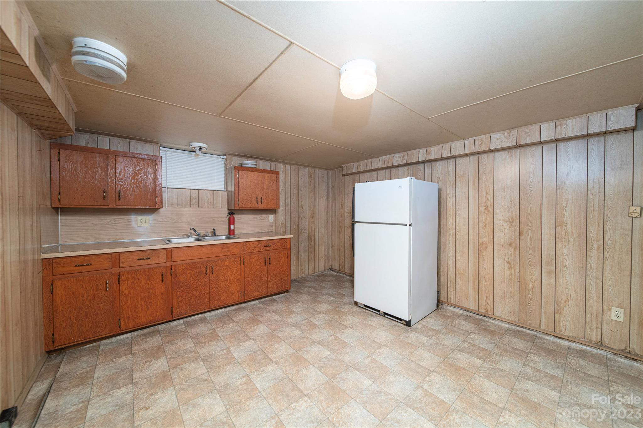 3980 Woodleaf Road Salisbury, NC 28147 - Photo 4 of 34 a large kitchen with a refrigerator and wooden cabinets