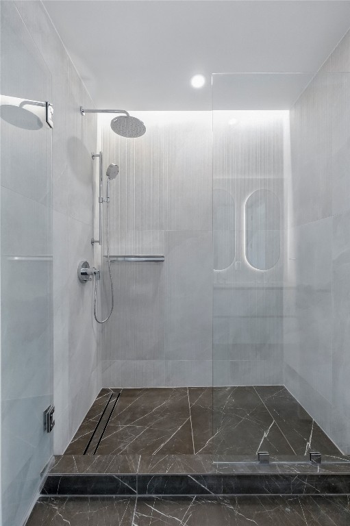 610 Davis Street, Unit 3104 Austin, TX 78701 - Photo 14 of 40 Full bath featuring walk in shower, dark marble finish floors, and recessed lighting