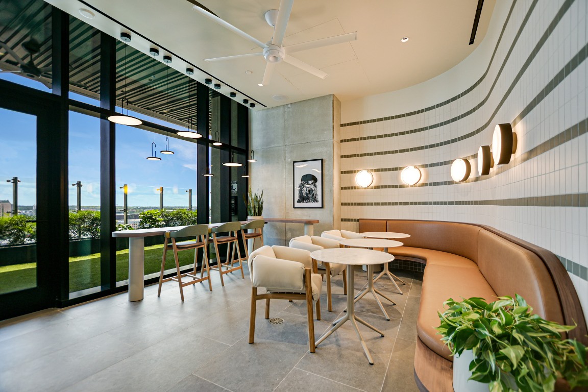 610 Davis Street, Unit 3104 Austin, TX 78701 - Photo 36 of 40 Community lobby featuring floor to ceiling windows, tile walls, and a towering ceiling