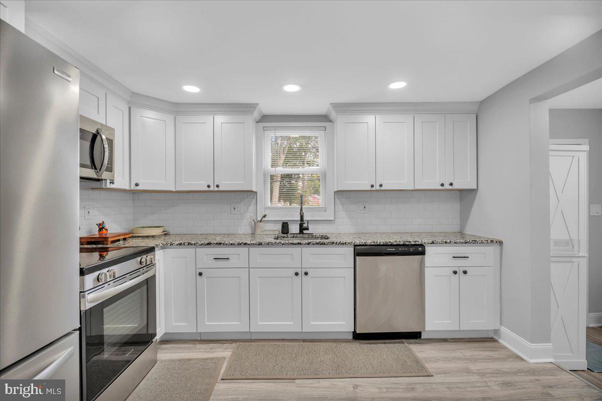 501 Rhoads Avenue Haddonfield, NJ 08033 - Photo 9 of 29 a kitchen with granite countertop white cabinets and appliances
