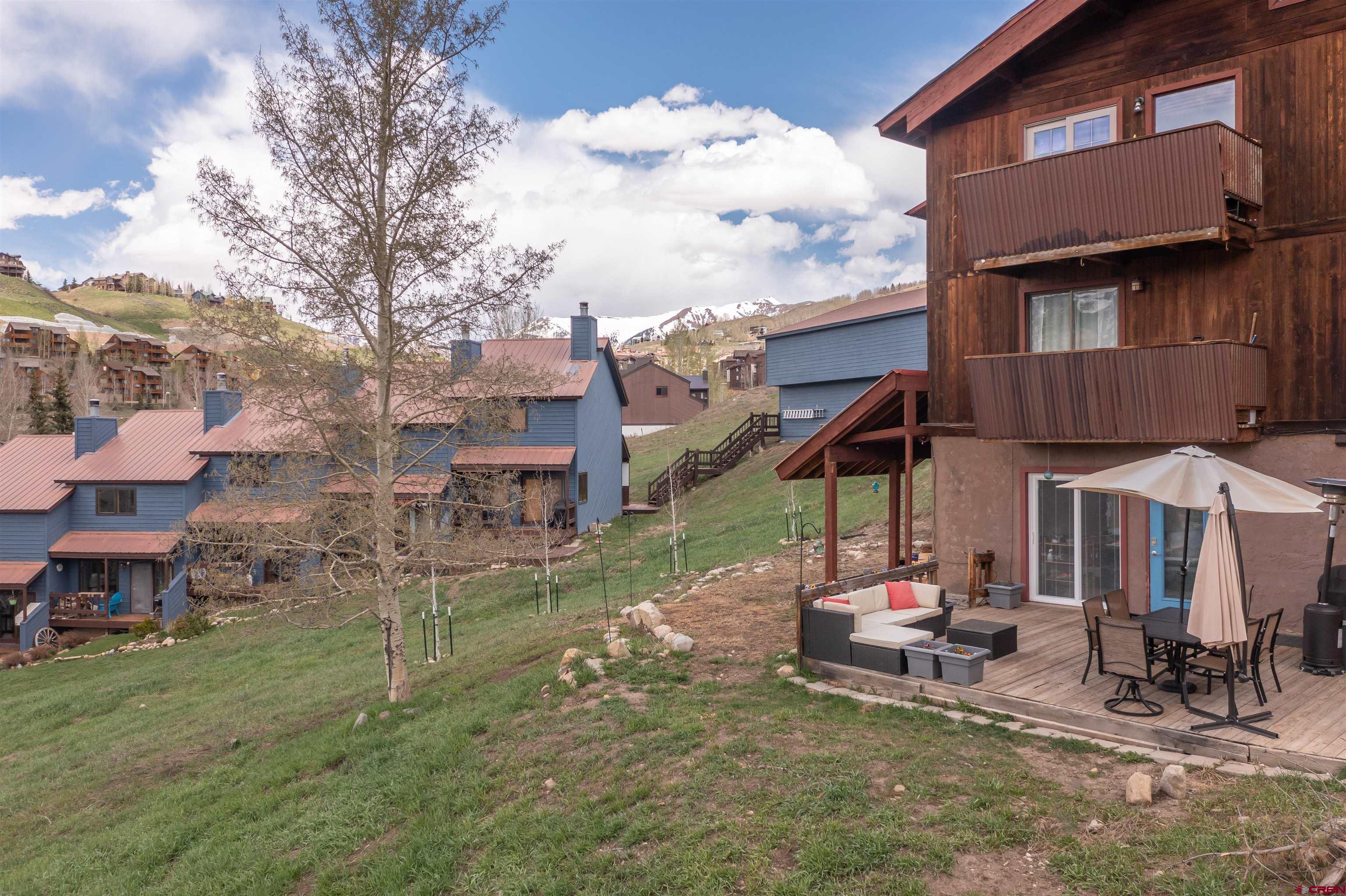 31 Castle Road, Unit 1 Crested Butte, CO 81225 - Photo 14 of 17 a view of a house with backyard porch and sitting area