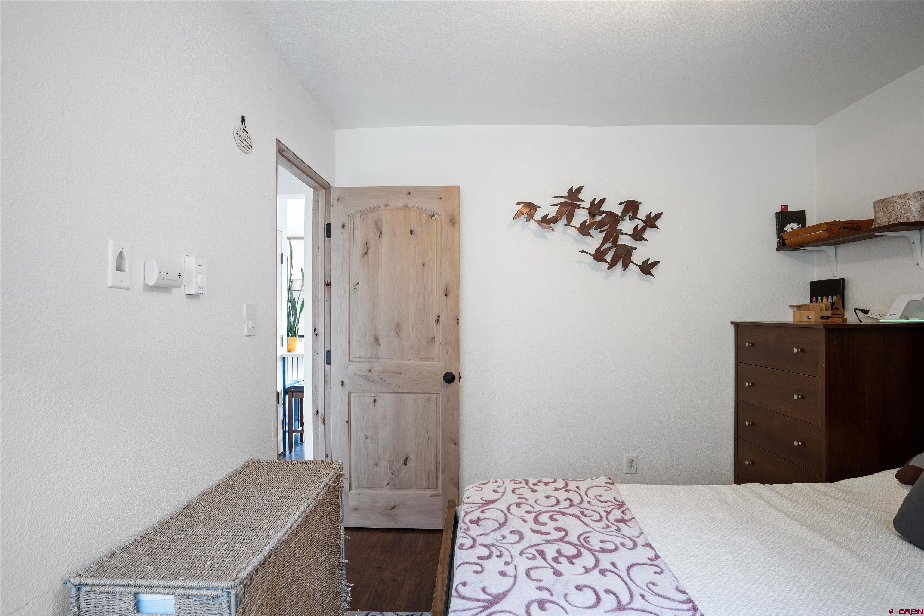 31 Castle Road, Unit 1 Crested Butte, CO 81225 - Photo 9 of 17 a bedroom with a dresser and a chandelier
